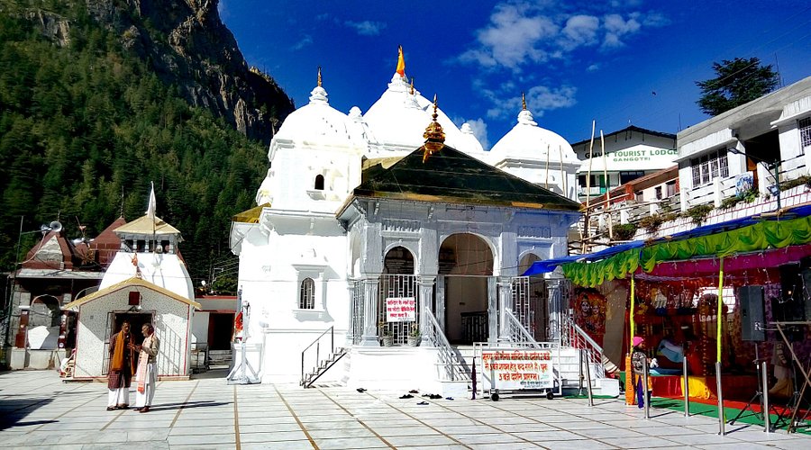 A beautiful view of the Gangotri Temple with the Bhagirathi River flowing beside it, surrounded by mountains